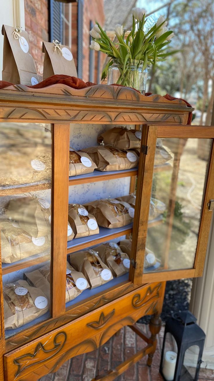 a display case filled with lots of items on top of a brick floor next to a door