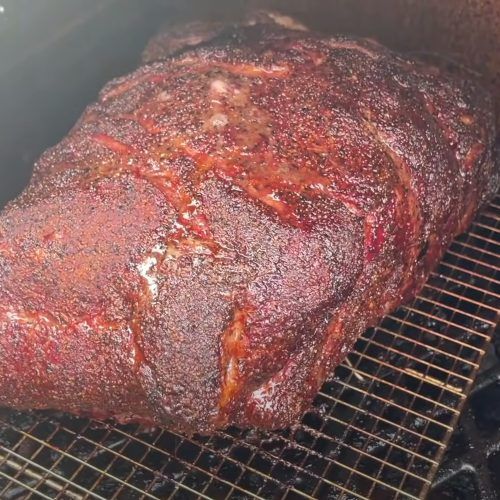 a large steak is cooking on the grill