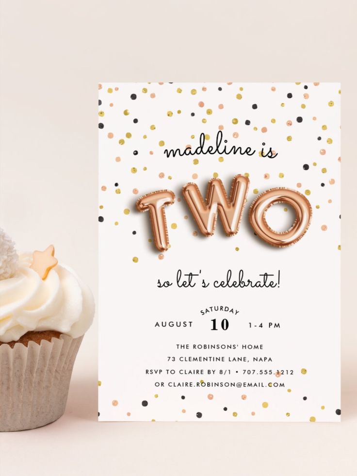 a cupcake next to a card that says two, so let's celebrate