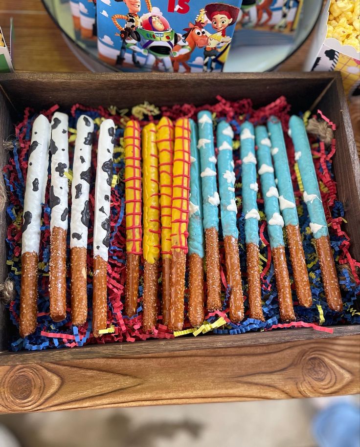 a wooden box filled with lots of different colored candles