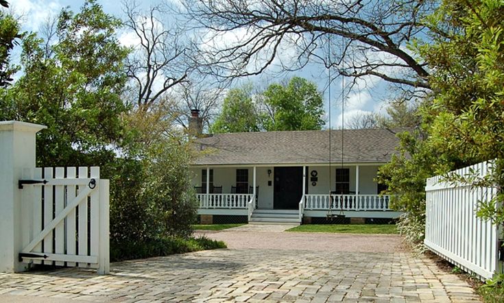 a house with a white picket fence in front of it