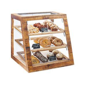 a wooden display case filled with lots of different types of donuts and muffins