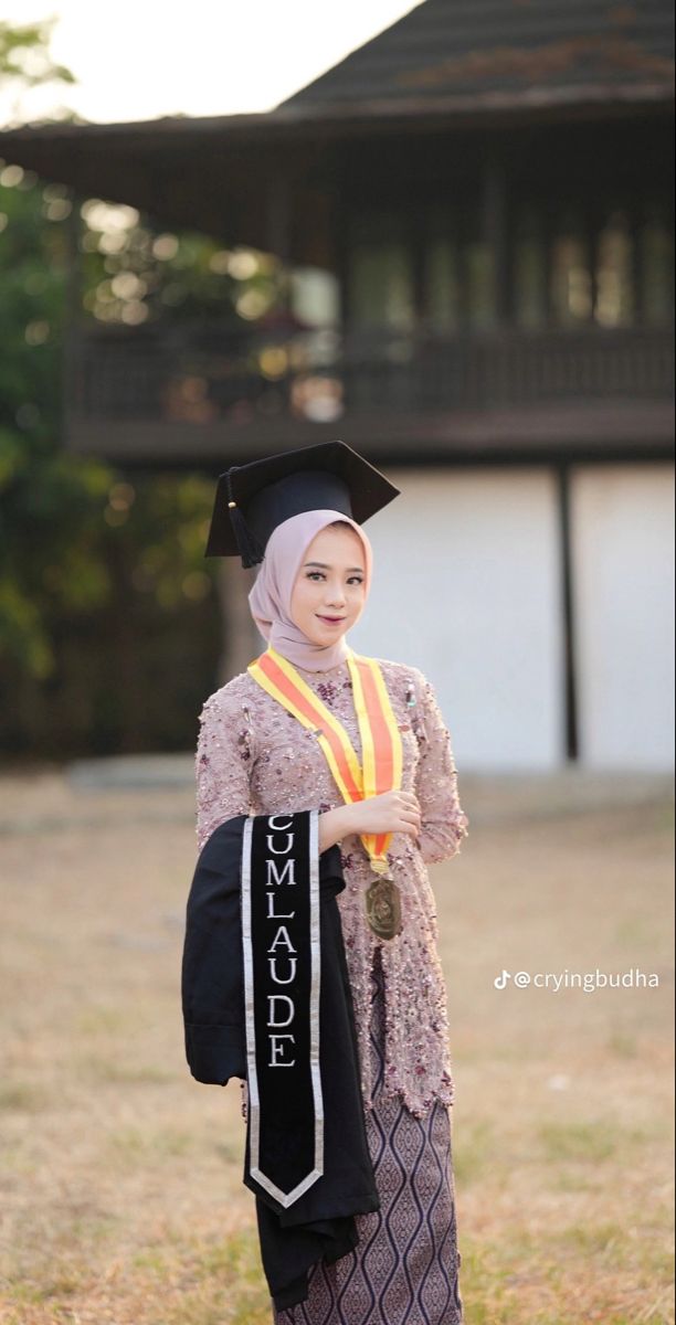 a woman wearing a graduation gown and holding a backpack