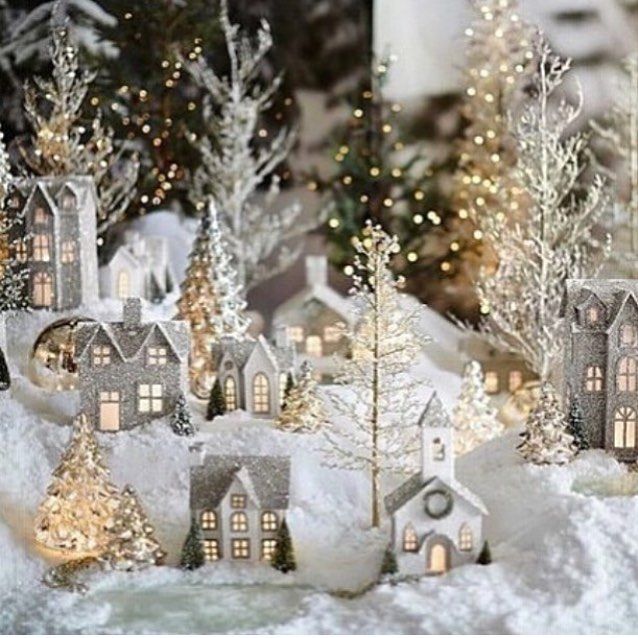 a small christmas village with trees and lights