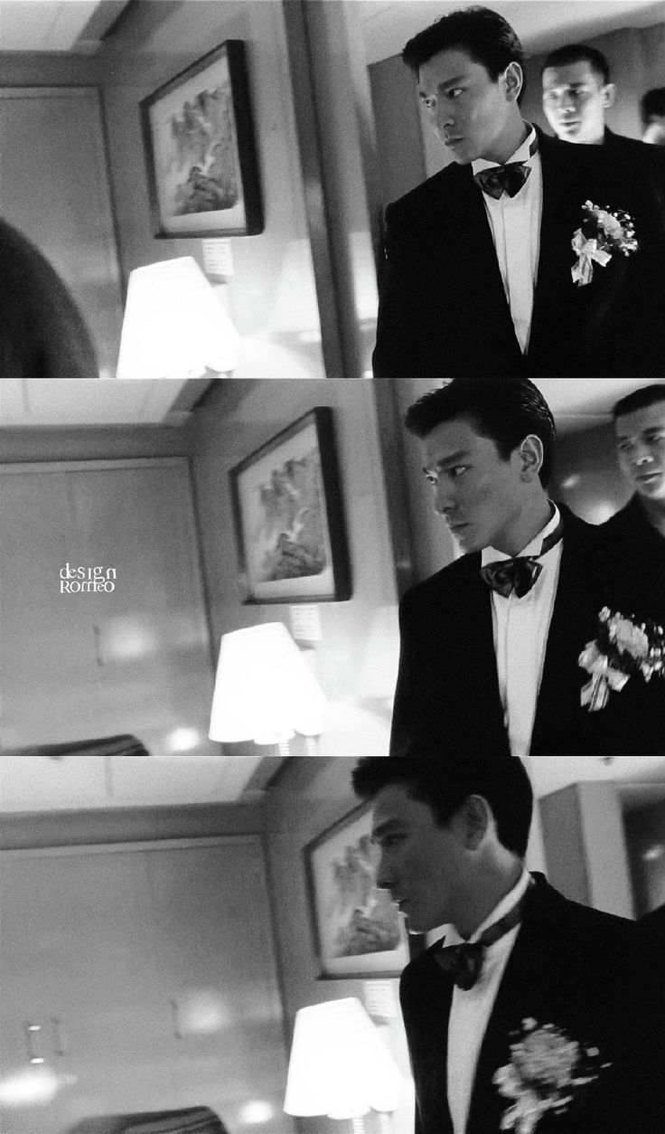 black and white photo of two men in tuxedos, one with flowers on his lapel