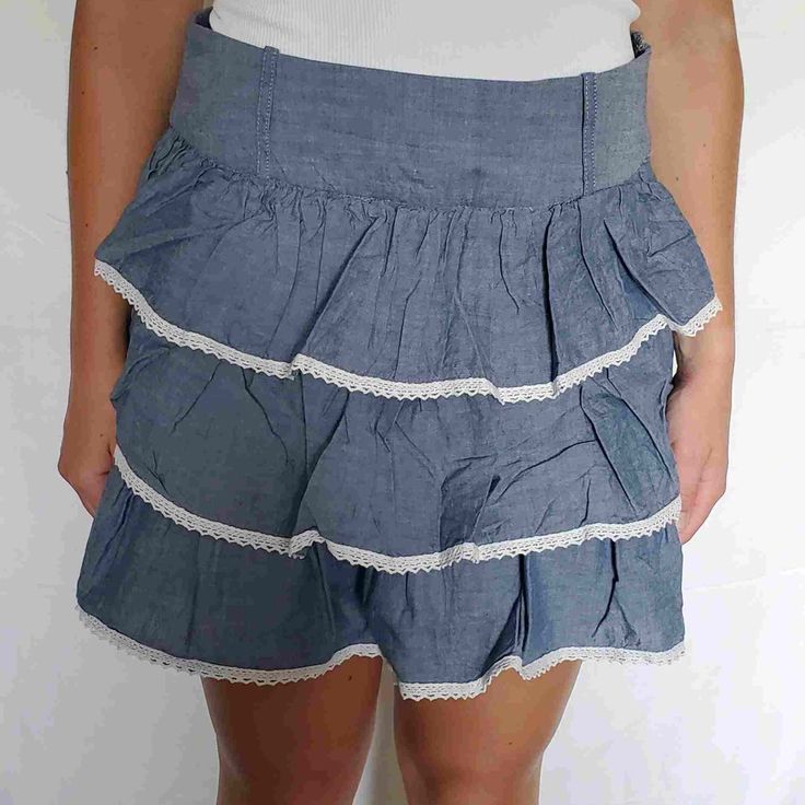 Blue Vanity Ruffled Skirt With White Trim Detail Never Worn Chic Blue Tiered Bottoms, Casual Blue Tiered Bottoms, Skirted Blue Bottoms With Ruffles, Blue Skirted Bottoms With Ruffles, High Waist Cotton Skort With Ruffled Skirt, High Waist Cotton Mini Skirt With Ruffles, High Waist Cotton Ruffled Skort, Casual Ruffled Mini Skort, Tiered Cotton Mini Skirt For Spring