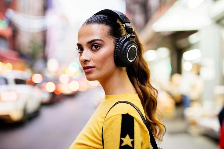 a woman wearing headphones on the street