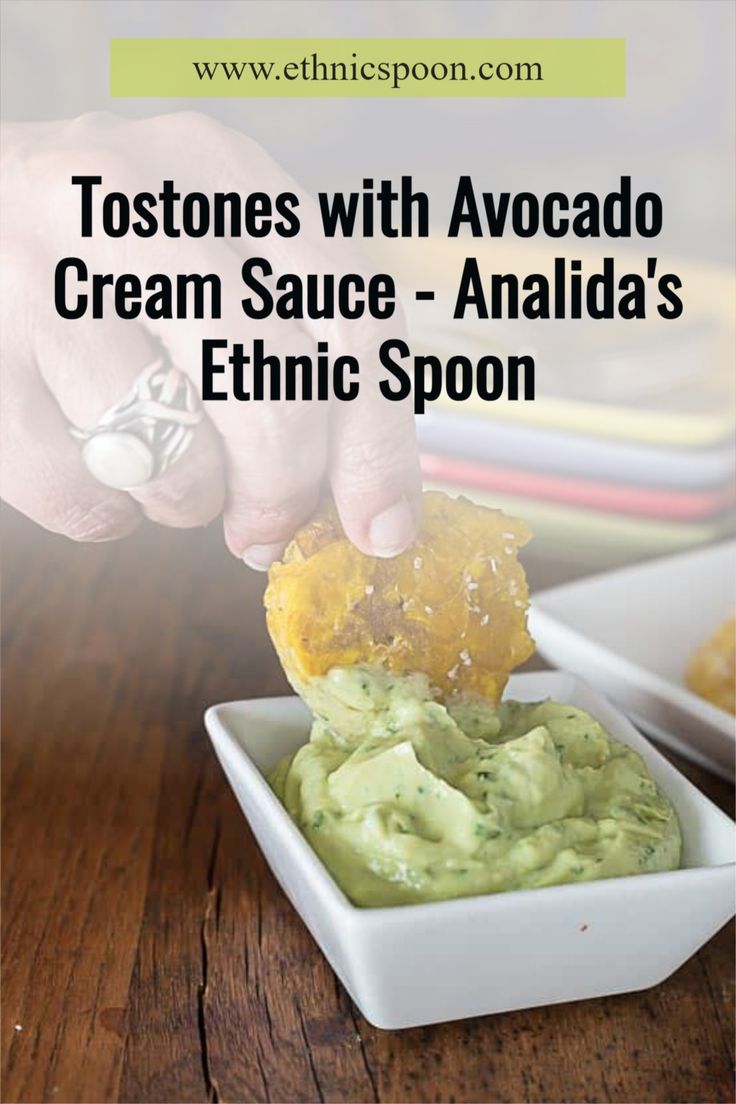 a person dipping guacamole into a white bowl with the words, tostones with avocado cream sauce - anila's ethnic spoon