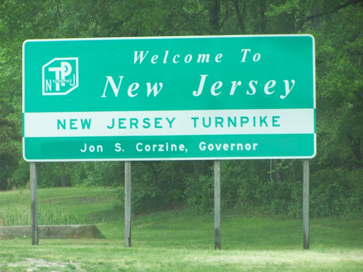 a green and white welcome sign to new jersey