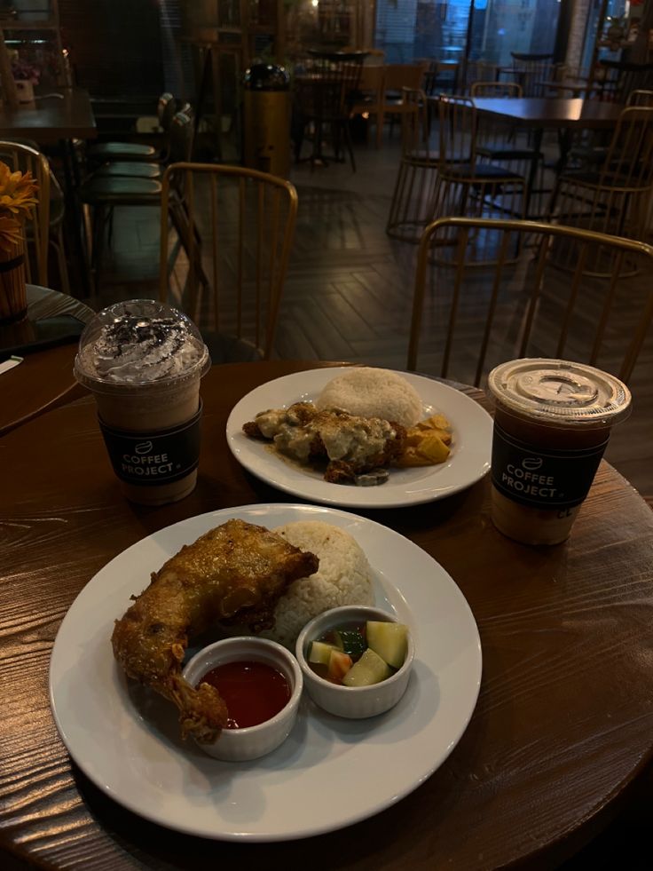 two plates with food on them sitting on a table