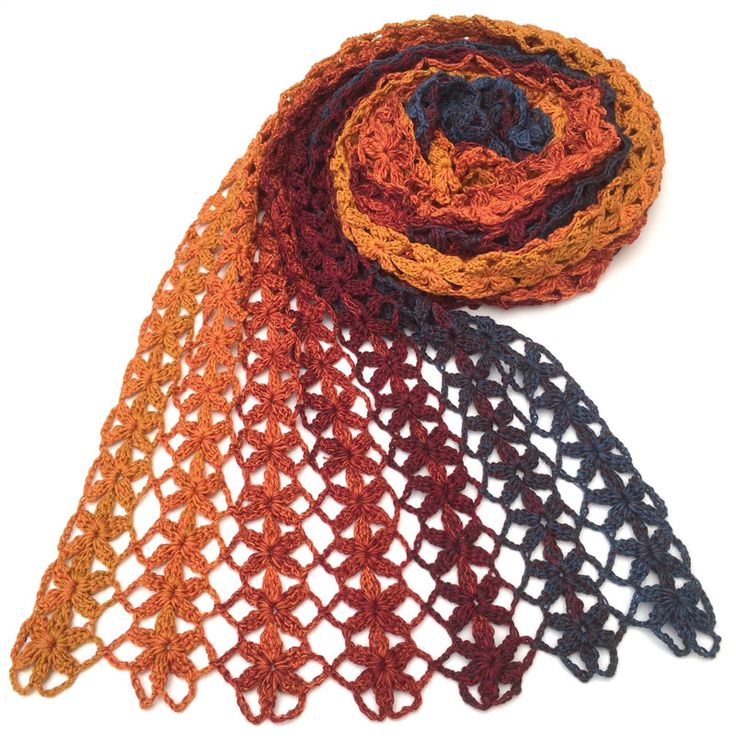 two crocheted scarves sitting on top of each other