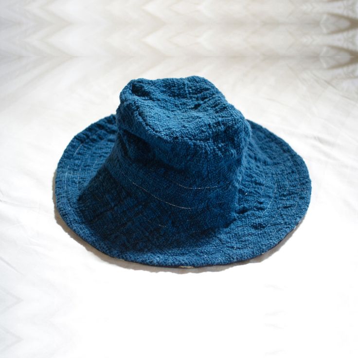 A reversible bucket hat inspired by the wide-brimmed floppiness of fantastical wizard hats, alluding to a connection to another invisible world that may grant protection and safe passage on a voyage. The + symbol, or tapak dara, often painted at the front gates of homes in Bali, is believed to ward off troublesome spirits. 100% handwoven organic cotton 100% hand painted batik 100% botanical dyes GOTS certified organic cotton sewing thread Cut and sewn with care in Bali Limited stock available fo Bohemian Blue Bucket Sun Hat, Bohemian Blue Brimmed Bucket Hat, Handmade Blue Brimmed Bucket Hat, Handmade Blue Bucket Hat One Size, Adjustable Blue Bucket Hat, Botanical Dyeing, Front Gates, Hats For Sale, Sewing Thread