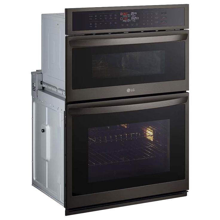 two ovens side by side, one with the door open and the other with the light on