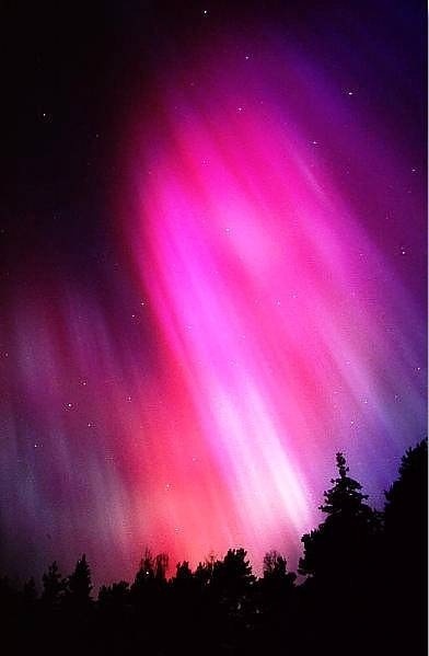 an aurora bore is seen in the night sky