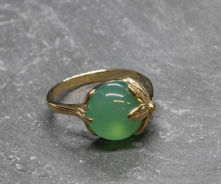 Emerald Gold Ring set with a Created Emerald in a green color, at size 12mm (7 Cts).Gold Vermeil: 18k Gold over Solid 925 Sterling Silver ☞ made to last. Click here for ☞ Matching Earrings Matching Pendant - please ask me Details:• Created Emerald in a green• Emerald: 12mm, 7 Cts, cabochon cut• Dimensions: Band width ≈ 2.4mm, thickness ≈ 1.2mm• 18K Gold VermeilSKU 2368 Cheap Elegant Gemstone Rings, Solid Gold Rings With Stone, Womens Rings With Precious Stone, Colur Stones Gold Rings, Indian Gold Stone Rings, Indian Stone Ring, Emerald Ring Vintage Antique, Emerald Ring Design, Emerald Gold Ring