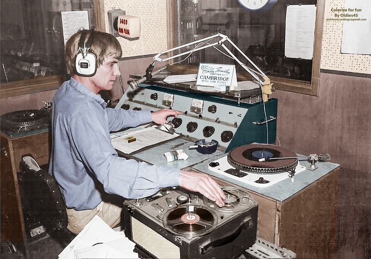 a man in headphones working on an old record player