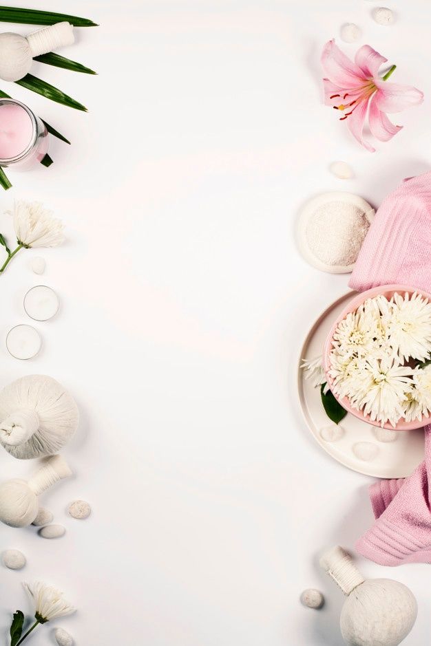 a table topped with flowers and candles next to white dishes filled with marshmallows