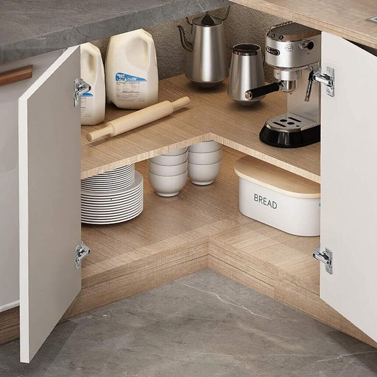 an open cabinet in the corner of a kitchen