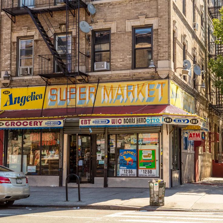 an empty street in front of a store with signs on the side of it that say sleep market