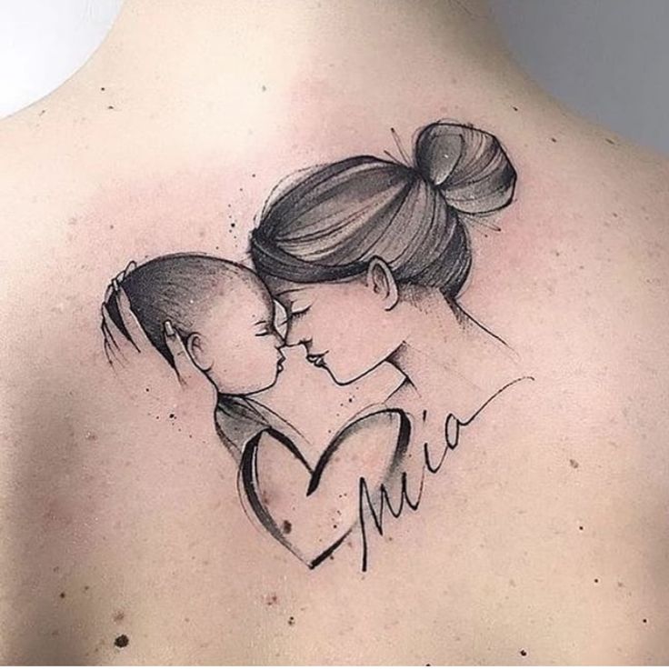 the back of a woman's shoulder with a drawing of a mother and child on it