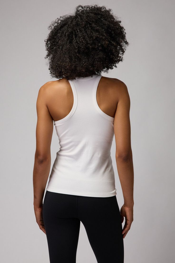 Sleek and slim. A regular to mid-length, slim fit tank with built-in shelf bra and racerback cut. Constructed in a flattering, thick-ribbed Modal Spandex blend material. | Slim Rib Tank Top in Stone High Stretch Racerback Top With Built-in Bra, Fitted Athleisure Tank Top With Built-in Bra, Solid Color Fitted T-back Activewear, Sporty High Stretch T-back Tank Top, Racerback Top With Built-in Bra And Medium Support, Fitted Tank Top With Built-in Bra For Workout, Stretch Moisture-wicking Racerback Tank Top, Moisture-wicking Stretch Racerback Tank Top, High Stretch T-back Workout Top