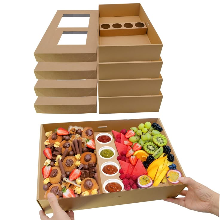 a person holding a box filled with different types of food