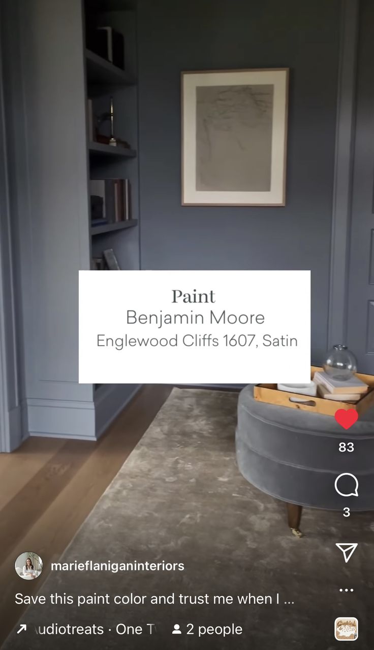 a living room with blue walls and furniture in the corner, along with a sign that reads paint benjamin moore engelwood cliffs