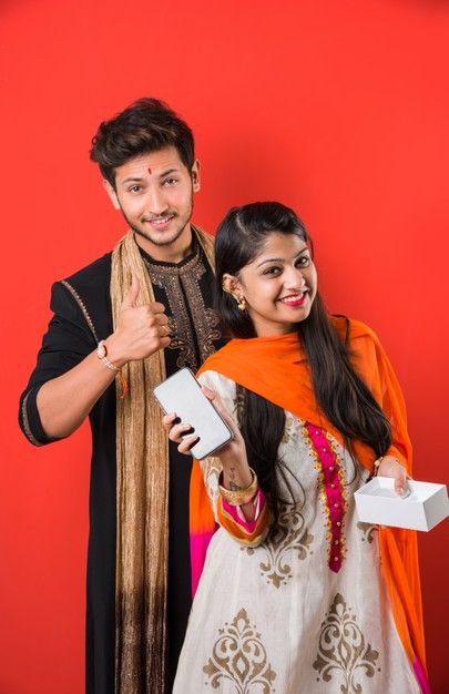 two people standing next to each other posing for the camera with boxes in their hands