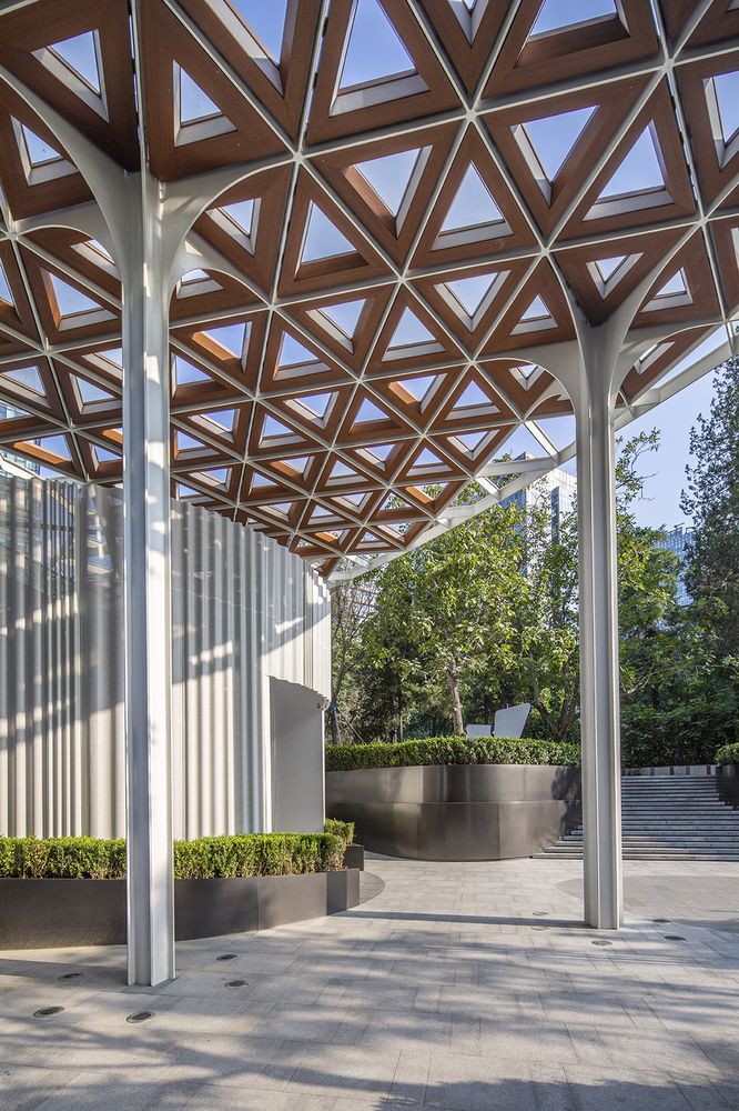 an outdoor covered area with benches and planters