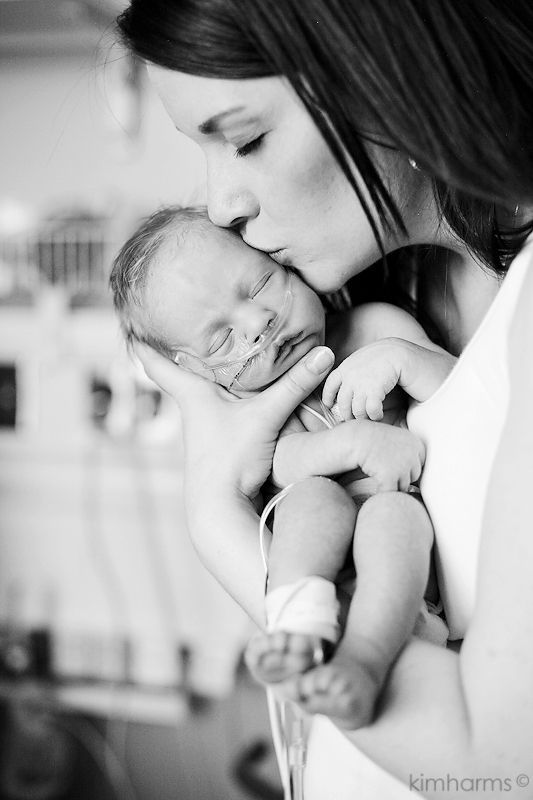 a woman holding a baby in her arms