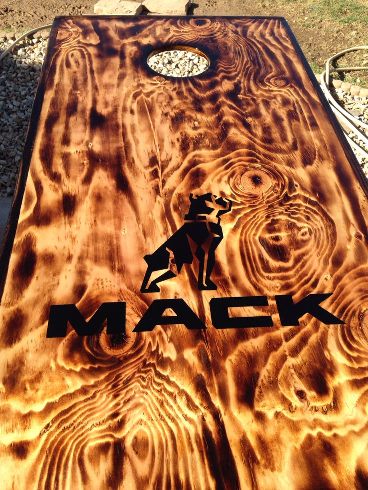 a close up of a cornhole board with the word mack on it and an image of a cowboy