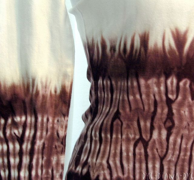 a white and brown tie dye shirt on a mannequin