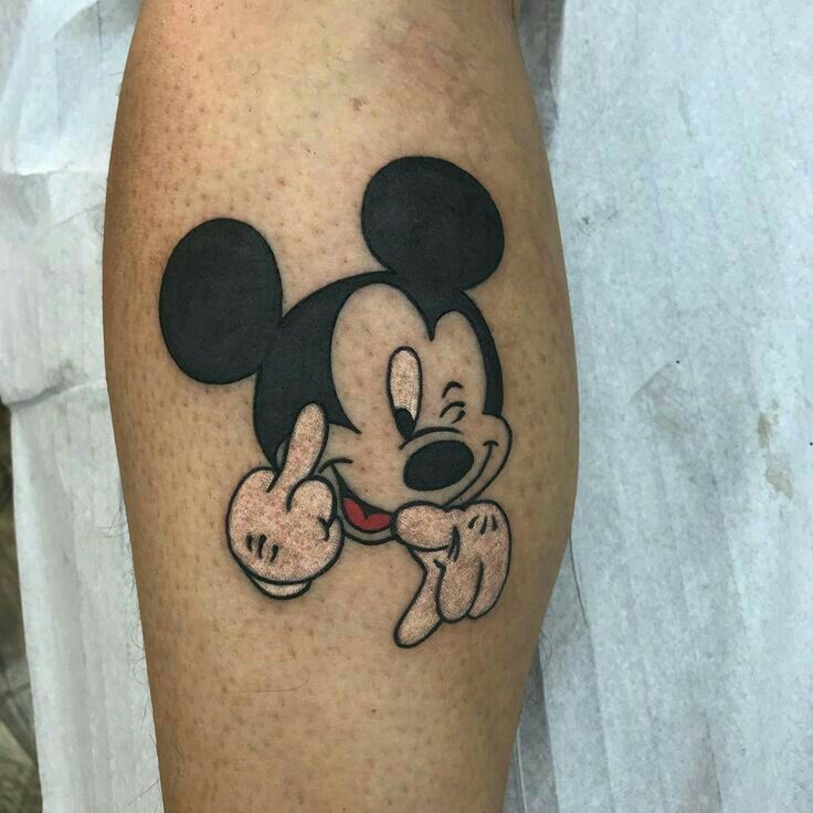 a person with a mickey mouse tattoo on their leg