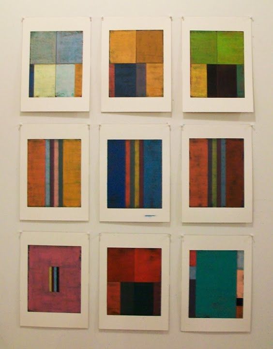 six different colored squares are arranged on the wall in an art gallery with white walls