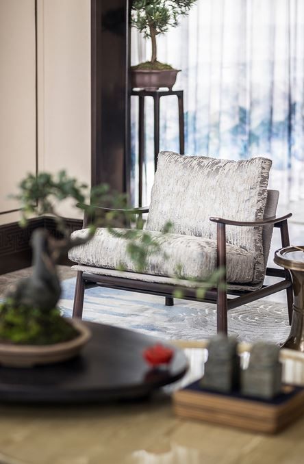 a living room filled with furniture and a potted plant on top of a table