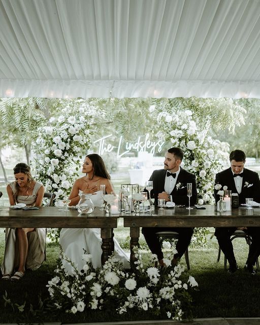 a group of people sitting at a long table