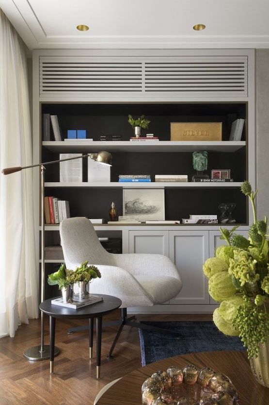 a living room filled with furniture and bookshelves