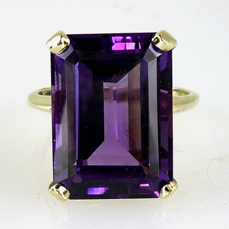 ALL OUR JEWELRY IS HANDCRAFTED IN THE U.S.A. All in for Amethyst?? This one needs to find its way into your collection! Featuring a rich purple color, and simple, classic mounting, even though this emerald-cut stone provides a ton of glorious purple flash, the ring is not at all bulky or uncomfortable. To the contrary, it is a feminine mounting that even the most demure jewelry lover can wear. The Amethyst is a stunning 14.88 carats-- a real attention-getter! The setting is made of solid 14k Yel Amethyst Jewelry Ring, Purple Flash, Gemstone Solitaire Ring, Amethyst Stones, Emerald Cut Rings, Etsy Gold Ring, Amethyst Jewelry, Solid Gold Rings, Purple Stones