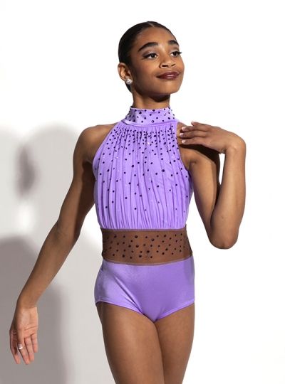 a woman in a purple leotard posing for the camera with her hands on her hips