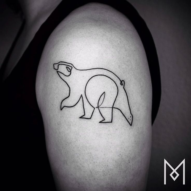 a black and white photo of a polar bear tattoo on the left upper half of the arm