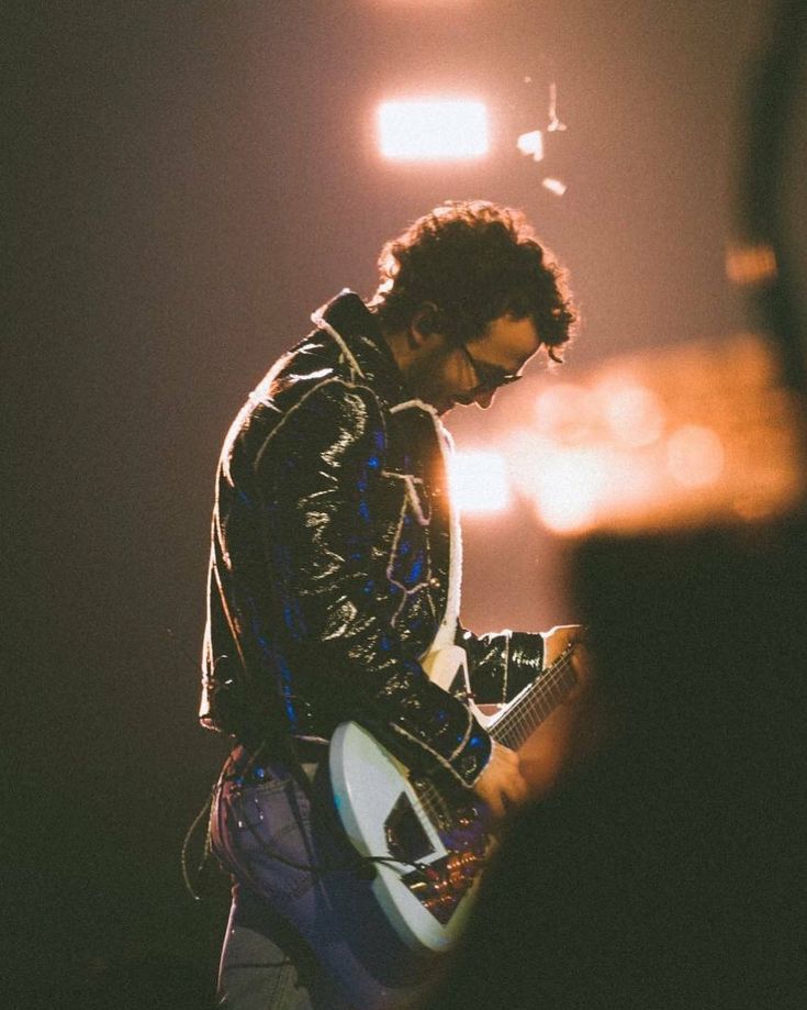 a man playing an electric guitar on stage