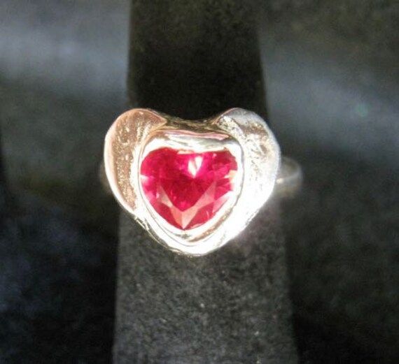 This is a one-of-a-kind heart gemstone ring that your loved one or friend is sure to treasure!  It lifts from the base of the band by 5 mm. This ring is formed from Art Clay Silver and is .999% silver. Valentine's Day Silver Heart Birthstone Ring, Silver Heart-shaped Birthstone Ring Gift, Heart-shaped Sterling Silver Birthstone Ring For Valentine's Day, Valentine's Day Heart-shaped Sterling Silver Birthstone Ring, Heart-shaped Silver Ruby Ring For Valentine's Day, Silver Heart-shaped Birthstone Ring, Heart-shaped Gemstone Ring For Valentine's Day, Silver Heart-shaped Ruby Ring, Silver Heart-shaped Ruby Ring For Anniversary