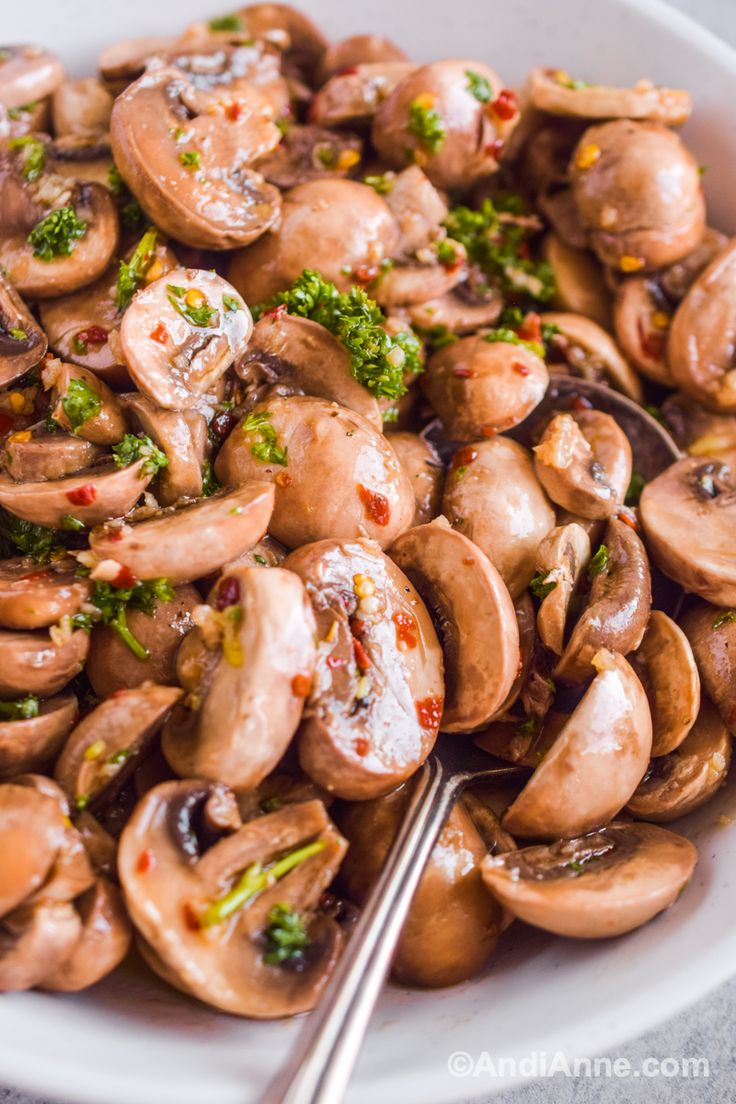 a white bowl filled with mushrooms and broccoli