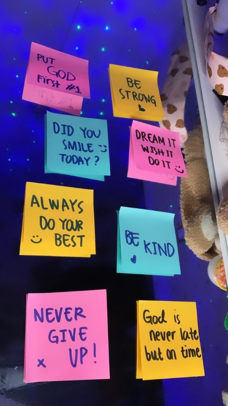 several sticky notes attached to a glass wall with a teddy bear in the middle and other words written on them