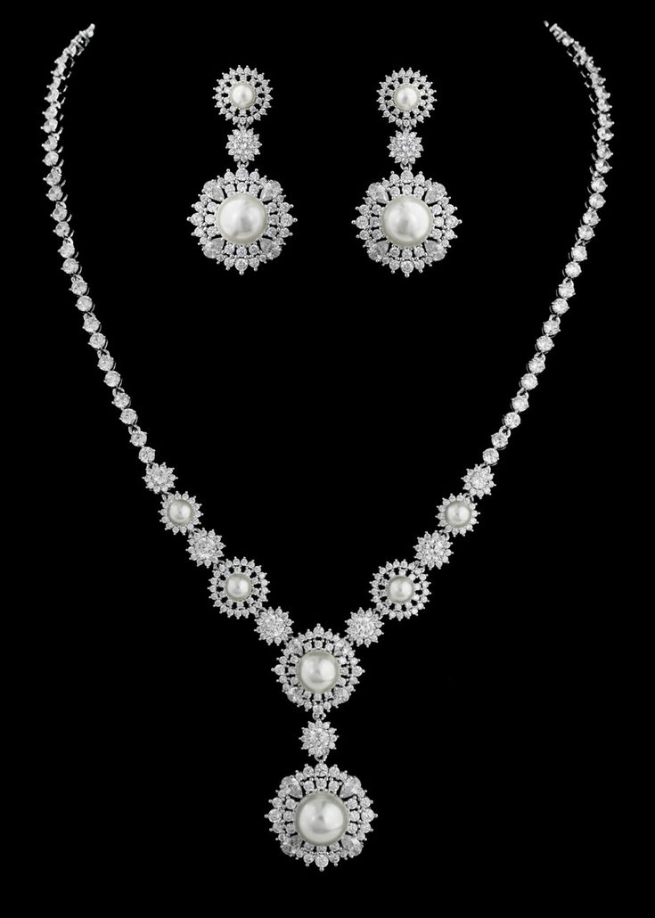 Pearl and CZ Bridal Jewelry Set This exquisite rhodium silver plated vintage inspired  jewelry set will dazzle on your wedding day. It features AAA quality round and pear cut cz crystals as well as lustrous diamond white glass pearls in a unique vintage inspired design.  This glamorous jewelry set will be a memorable part of your wedding day or any special occasion.Size: Necklace - 16" Long with a 1 3/4" long drop.  Pierced Earrings are about 1 1/2" long.Color: Silver/Diamond white/Clear.Style: Champagne Glasses Wedding, Vintage Wedding Accessories, Winter Wedding Accessories, Modern Vintage Wedding, Bridal Jewelry Ideas, Regal Wedding, Vintage Glam Wedding, Wedding Arbors, Crystal Bridal Jewelry Sets