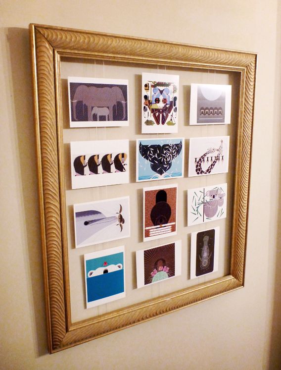 a gold frame with pictures hanging on the wall