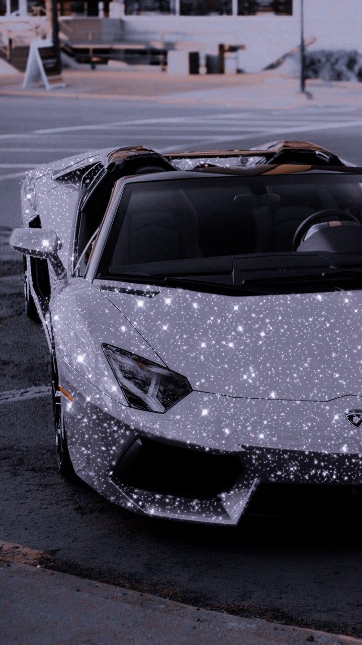 a white sports car parked in a parking lot