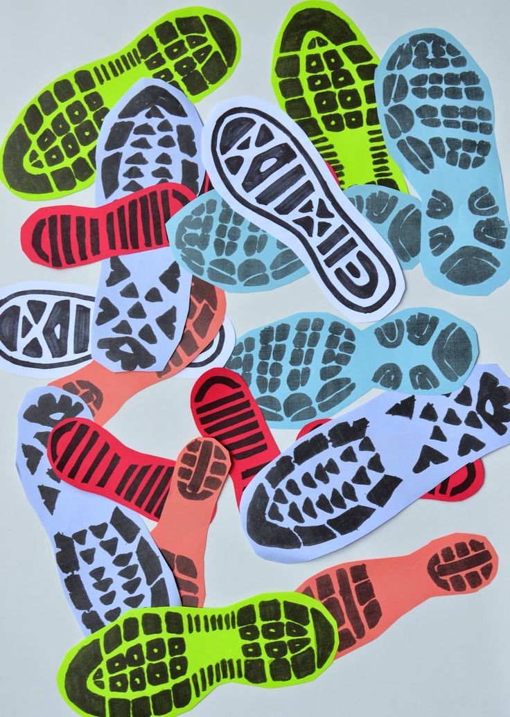 several pairs of running shoes stickers on a white surface