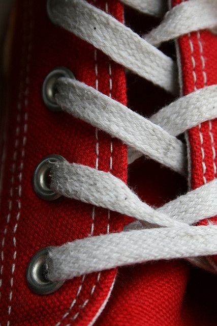 red and white sneakers with laces on them