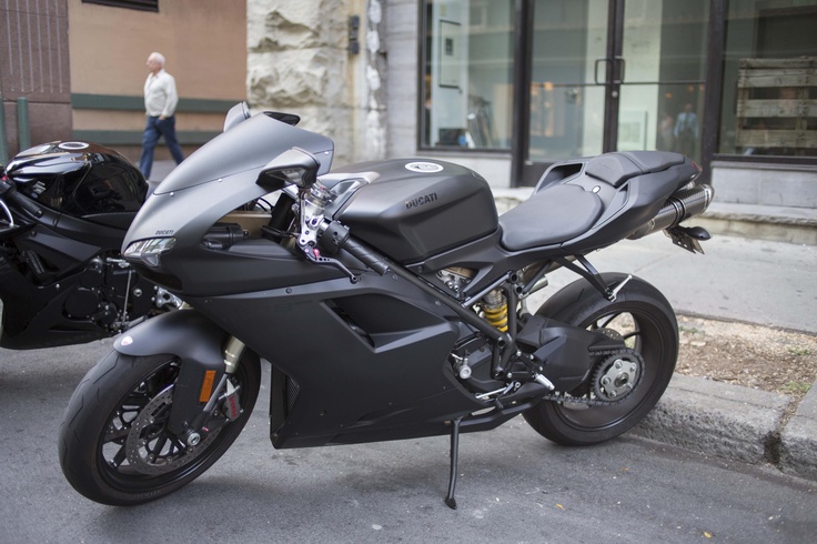 the motorcycle is parked on the side of the street